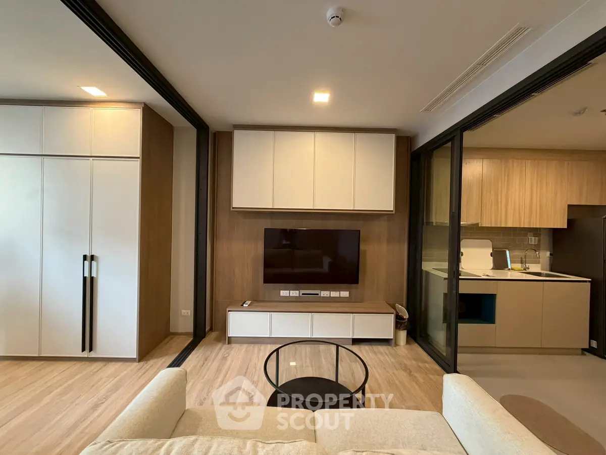 Modern living room with open kitchen and sleek design