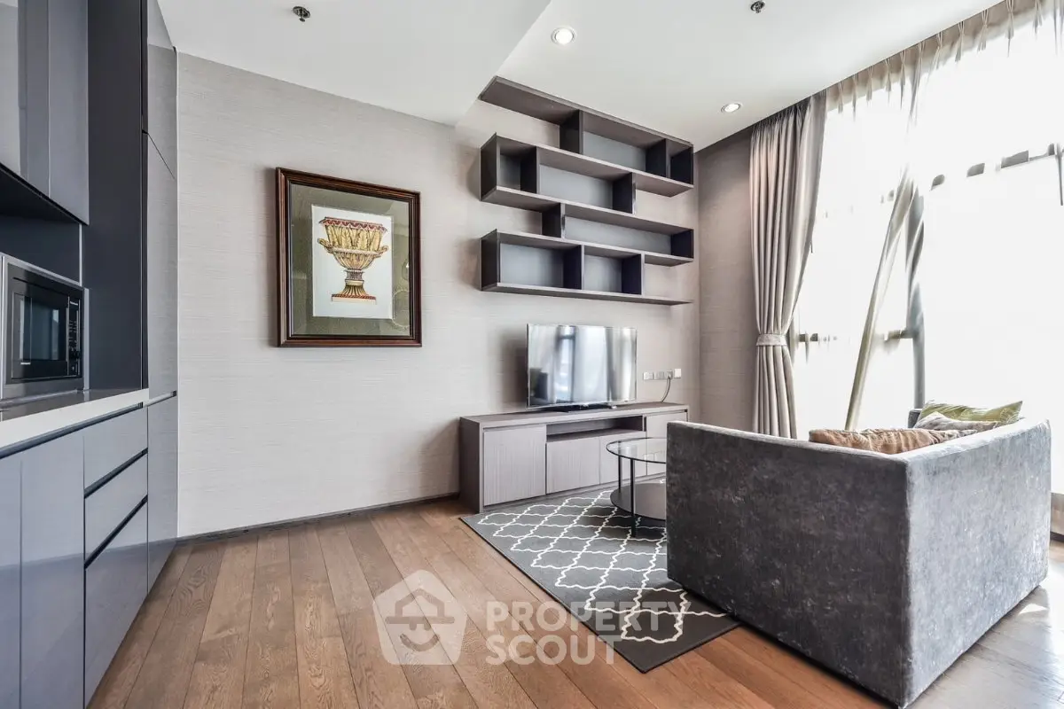 Modern living room with sleek furniture and large windows in a stylish apartment.
