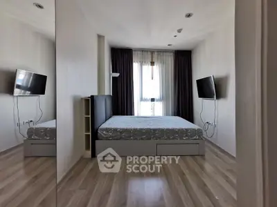 Modern bedroom with sleek design and wall-mounted TV