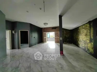 Spacious open layout with marble flooring and artistic wall design