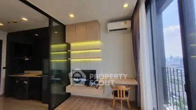 Modern living room with balcony view, sleek furniture, and built-in entertainment center in urban apartment.