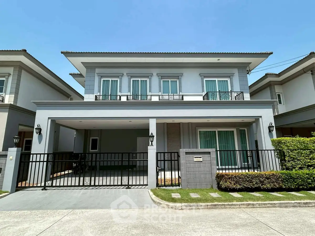 Modern two-story house with sleek design and spacious driveway in a serene neighborhood.