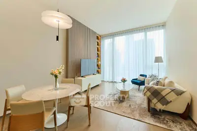 Elegant modern living room with stylish furniture and large windows offering city views.
