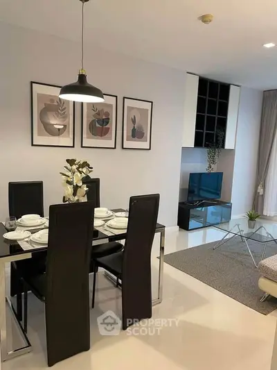 Modern dining and living area with sleek furniture and stylish decor in a contemporary apartment.