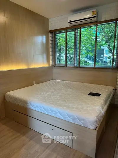 Modern bedroom with large window and built-in storage bed