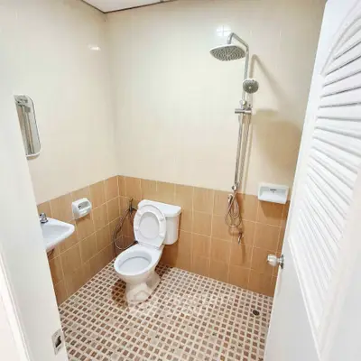 Modern bathroom with shower and toilet in neutral tones