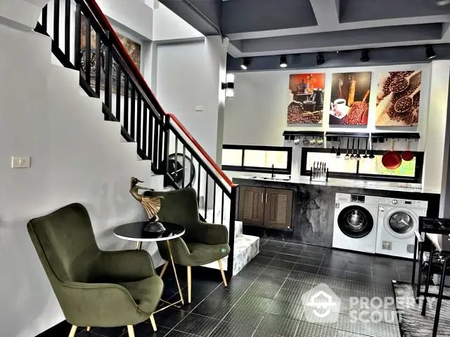 Stylish modern kitchen with washing machine and cozy seating area