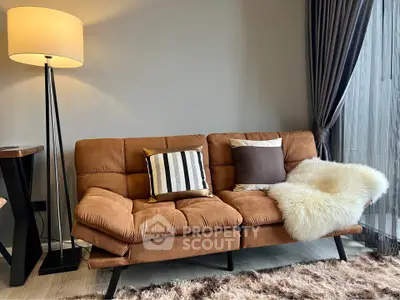Stylish living room with cozy brown sofa, elegant floor lamp, and plush rug in modern apartment.