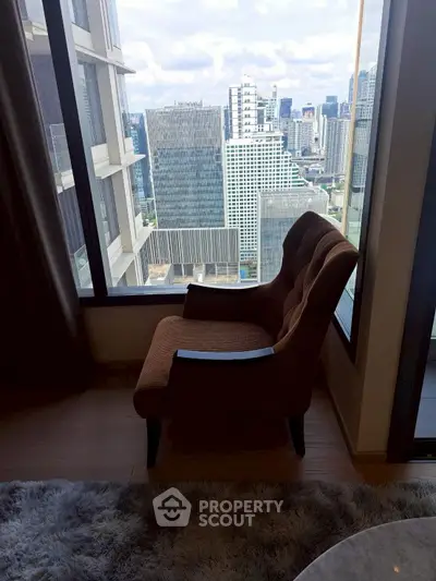 Modern living room with large windows and cozy seating area