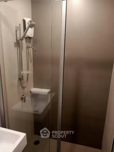 Modern bathroom with sleek shower enclosure and contemporary fixtures.