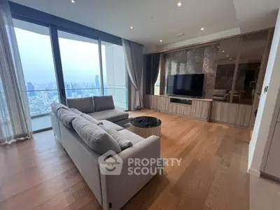 Luxurious living room with stunning city view and modern furnishings in high-rise apartment.
