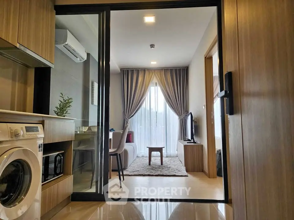 Modern apartment interior with washing machine and cozy living area