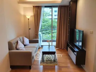 Cozy living room with modern decor and large window view.