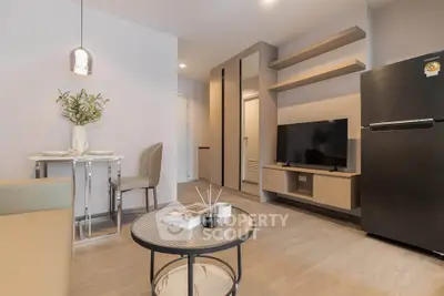 Modern living room with sleek furniture and flat-screen TV, perfect for urban living.