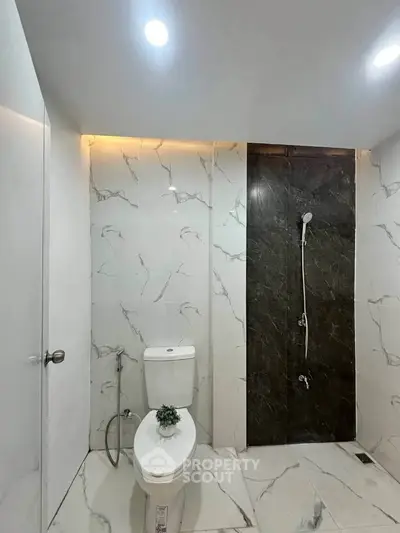 Modern bathroom with marble tiles and sleek shower design