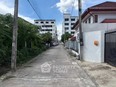 Charming residential street with modern houses and lush greenery, perfect for serene living.