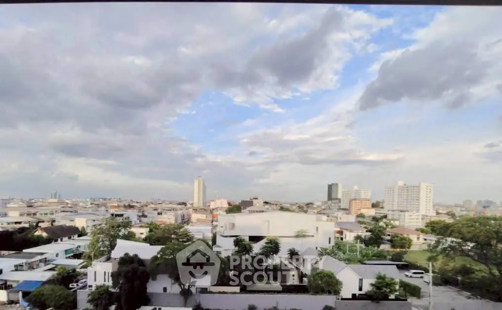 Stunning cityscape view from a high vantage point showcasing urban skyline and lush greenery.