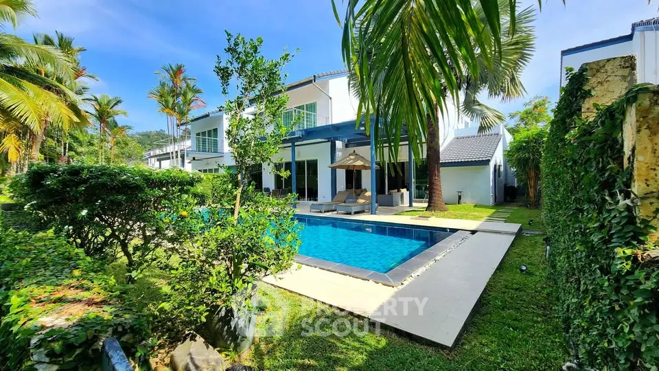 Luxurious villa with private pool and lush garden in tropical paradise setting.