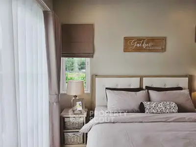 Cozy bedroom with elegant decor and natural light, perfect for relaxation.