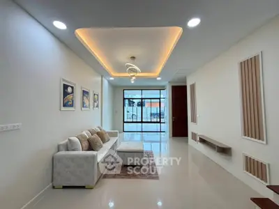 Modern living room with elegant ceiling lights and cozy sofa in a stylish apartment.