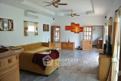 Spacious living room with modern decor and large windows for natural light.
