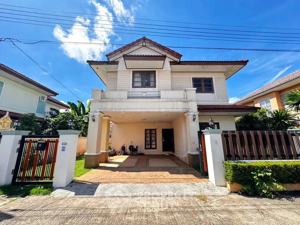 Charming two-story house with spacious driveway and lush greenery, perfect for family living.