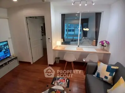 Modern living room with cozy seating and stylish decor in a contemporary apartment.