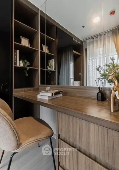 Modern study area with wooden desk and shelving, elegant decor and natural light.