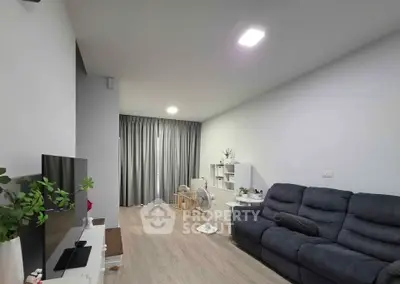 Spacious living room with modern decor and cozy seating area