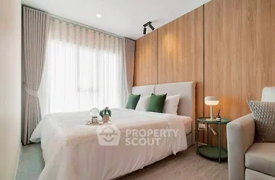Modern bedroom with stylish decor and natural light, featuring a cozy bed and elegant furnishings.
