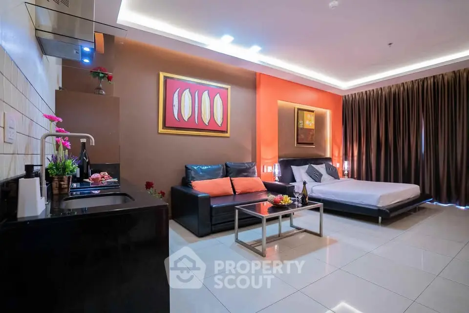 Modern studio apartment with open layout, featuring stylish kitchen and cozy living area.