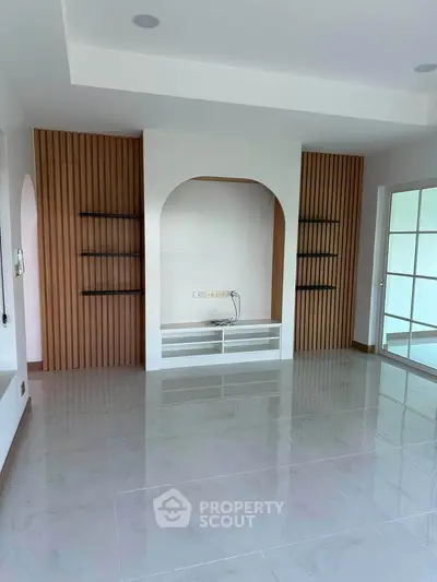 Spacious modern living room with sleek design and large windows for natural light.