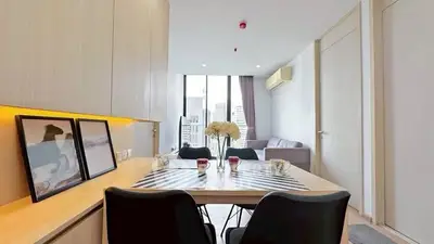 Modern living room with city view, stylish decor, and cozy seating area.