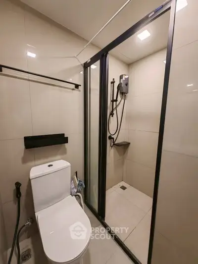 Modern bathroom with sleek shower enclosure and contemporary fixtures.