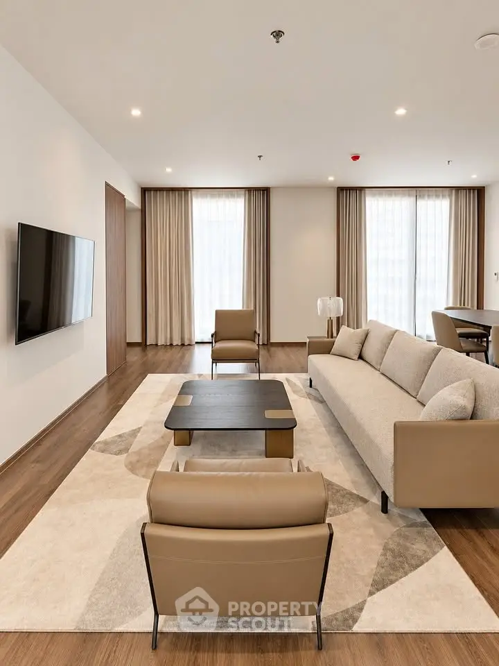 Spacious modern living room with elegant furniture and large windows for natural light.