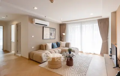 Modern living room with stylish furniture and natural light, perfect for relaxation and entertainment.