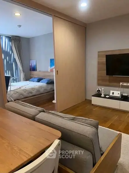 Modern open-plan living room with cozy bedroom and stylish decor