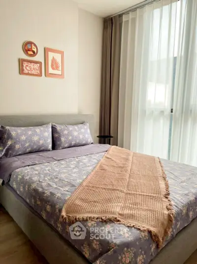 Cozy bedroom with floral bedding and soft lighting, perfect for relaxation.