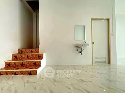 Modern minimalist interior with marble flooring and staircase