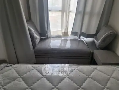 Elegant bedroom with plush bedding and large window for natural light.