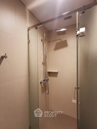 Modern bathroom with glass shower enclosure and sleek fixtures