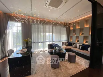 Luxurious living room with elegant decor and large windows offering natural light and scenic views.