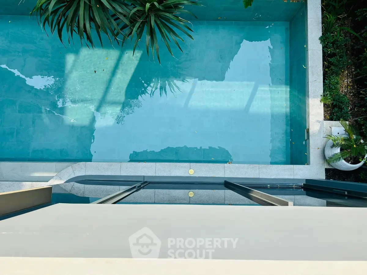 Luxurious modern pool with sleek design and lush greenery, perfect for relaxation and entertainment.