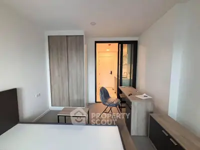 Modern bedroom with sleek furniture and ample storage in a stylish apartment.