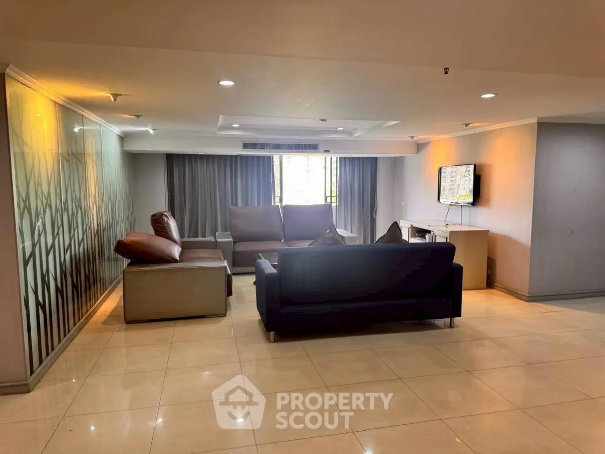 Spacious living room with modern furniture and large windows for natural light.
