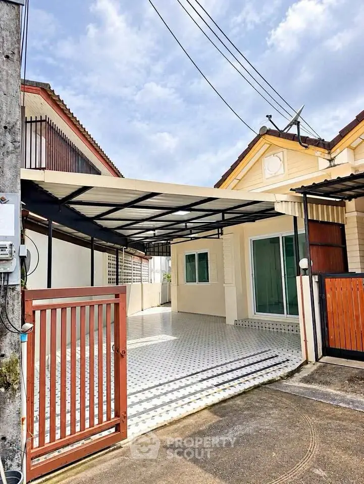 Charming single-story home with covered carport and gated entrance, perfect for modern living.
