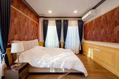Luxurious bedroom with elegant decor and natural light, featuring stylish curtains and a cozy bed.
