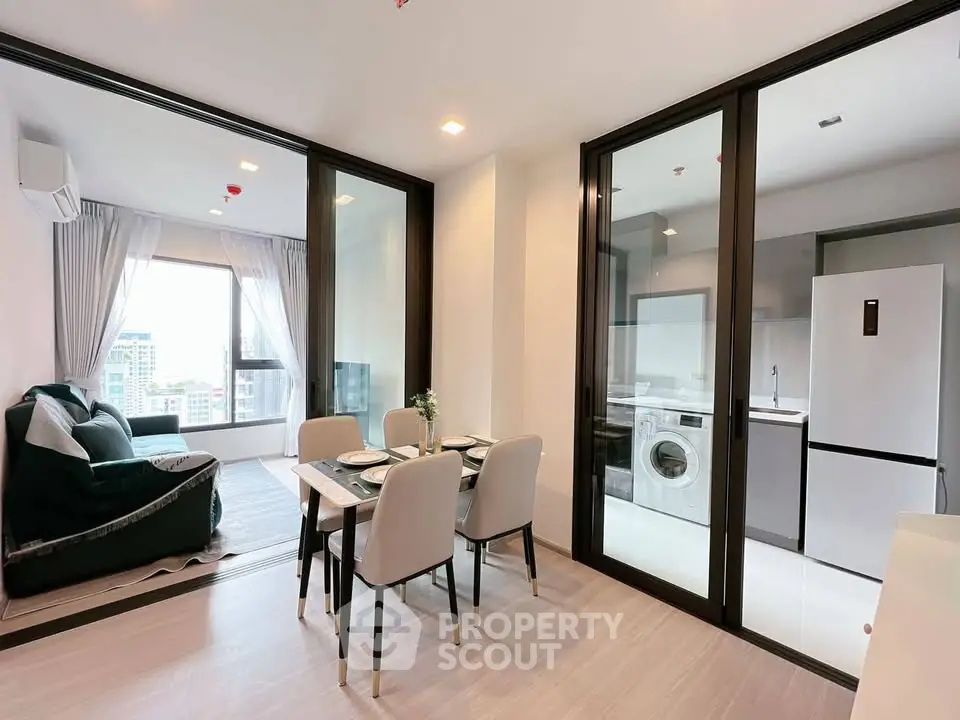 Modern apartment with open living and dining area, featuring a sleek kitchen and city view.