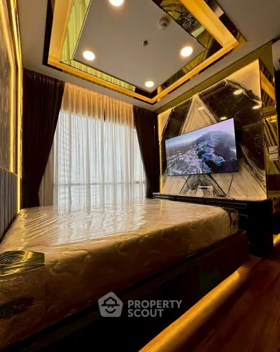 Luxurious bedroom with modern decor and large TV, featuring elegant lighting and floor-to-ceiling windows.