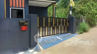 Modern gated entrance with sleek design and vibrant colors, perfect for contemporary homes.